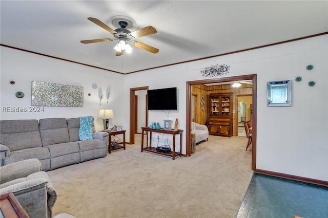 carpeted living room featuring ornamental molding and ceiling fan