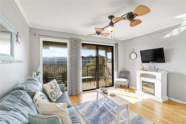 living room featuring crown molding, ceiling fan, and light hardwood / wood-style floors