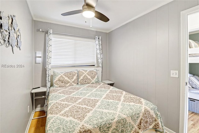 bedroom with ceiling fan, ornamental molding, and hardwood / wood-style floors