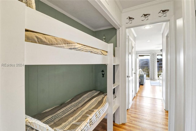 bedroom with hardwood / wood-style flooring and crown molding