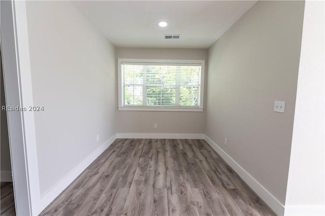 spare room with wood-type flooring