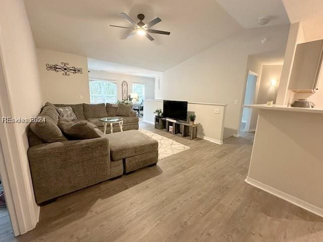 living room featuring lofted ceiling, wood-type flooring, and ceiling fan