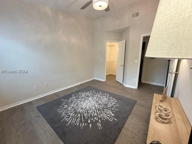 unfurnished bedroom with dark hardwood / wood-style floors and ceiling fan