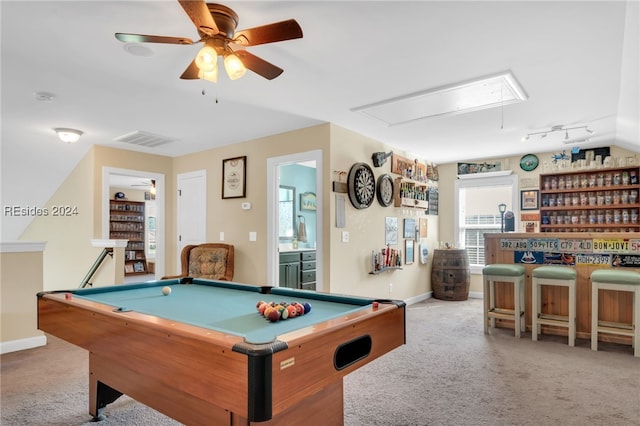 rec room featuring billiards, rail lighting, ceiling fan, light colored carpet, and indoor bar