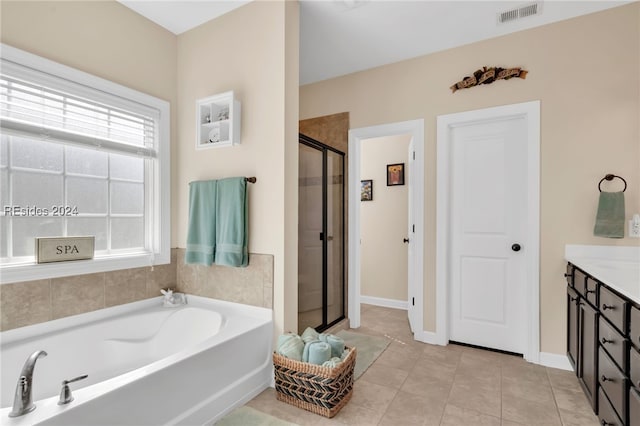 bathroom featuring tile patterned floors, vanity, and independent shower and bath