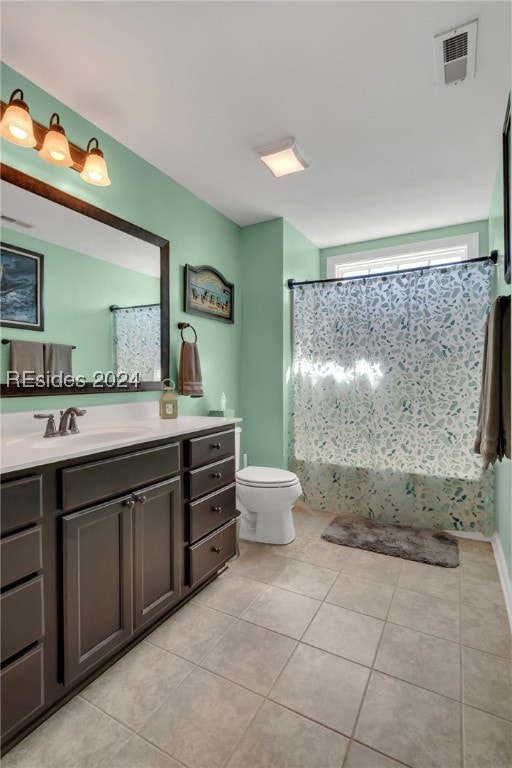 bathroom with vanity, curtained shower, tile patterned floors, and toilet