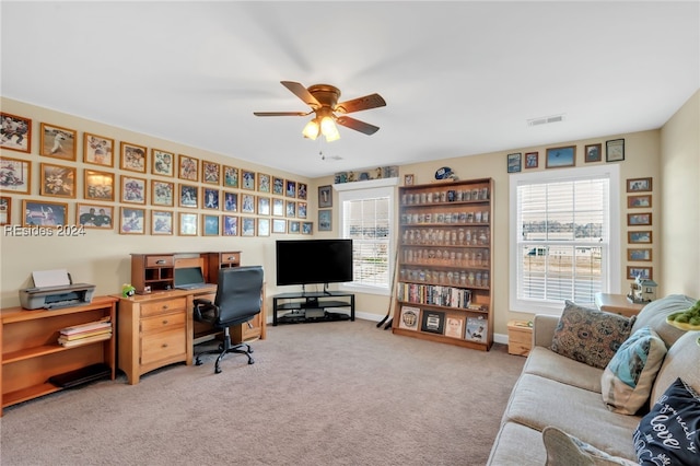 office space with ceiling fan and carpet