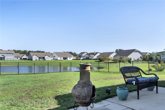 view of yard featuring a water view and a patio