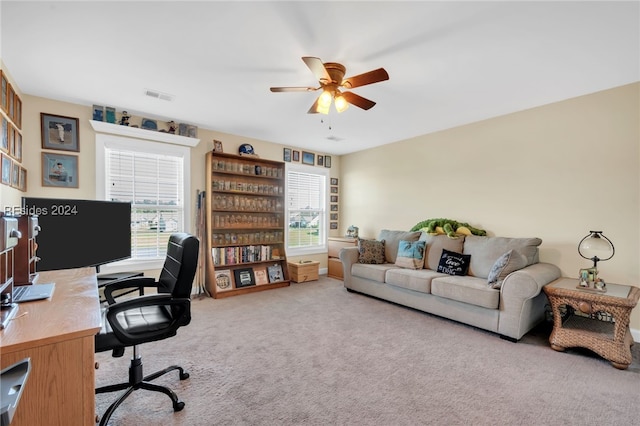 carpeted home office with ceiling fan