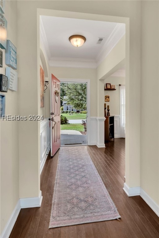 entrance foyer with dark wood-type flooring and ornamental molding