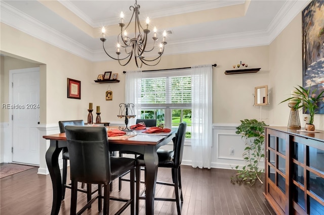 dining room featuring crown molding, a tray ceiling, and dark hardwood / wood-style floors