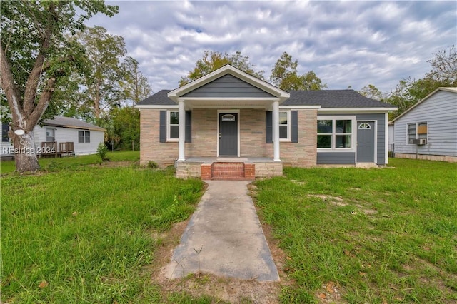 bungalow-style home featuring a front yard and covered porch