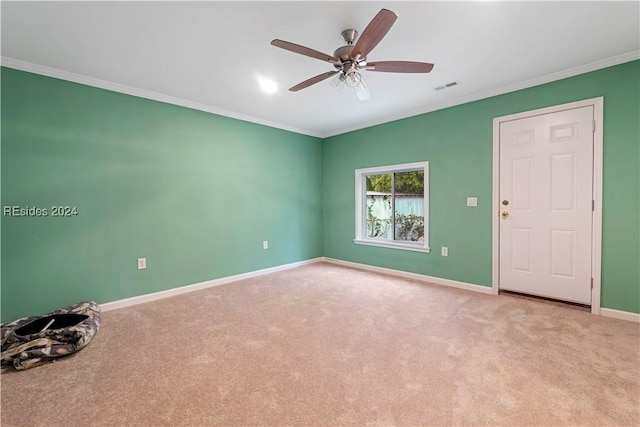 unfurnished room with crown molding, ceiling fan, and light carpet