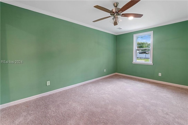 spare room with ornamental molding, carpet flooring, and ceiling fan