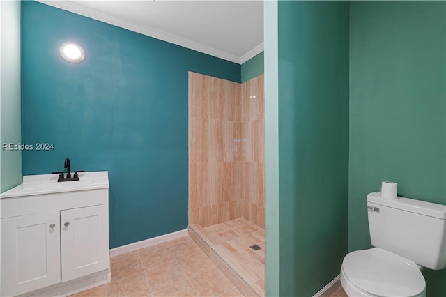 bathroom featuring a tile shower, vanity, ornamental molding, toilet, and tile patterned floors