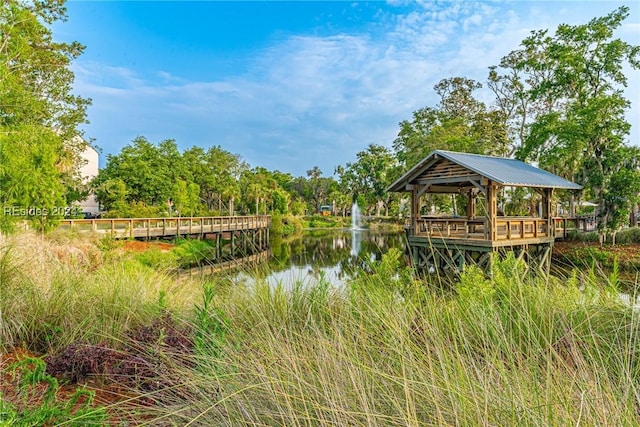 view of dock featuring a water view and a gazebo