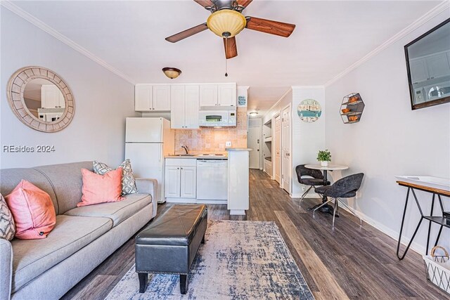 living room with ceiling fan, ornamental molding, dark hardwood / wood-style floors, and sink