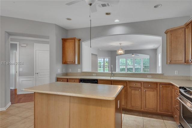 kitchen featuring sink, light tile patterned floors, ceiling fan, stainless steel appliances, and a center island