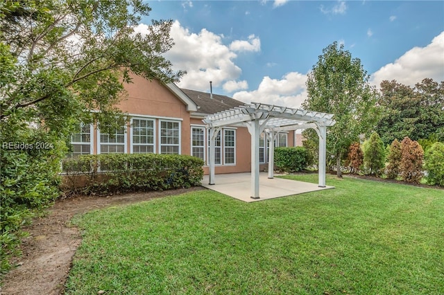 back of house featuring a yard, a patio area, and a pergola