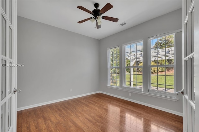 spare room featuring hardwood / wood-style floors and ceiling fan