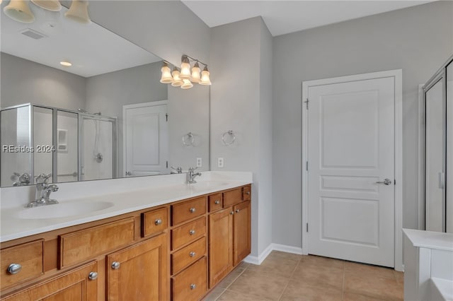 bathroom featuring tile patterned flooring, vanity, and an enclosed shower