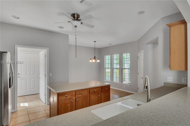 kitchen with stainless steel fridge with ice dispenser, pendant lighting, sink, light tile patterned floors, and kitchen peninsula