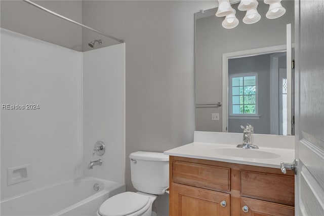 full bathroom featuring vanity, washtub / shower combination, and toilet