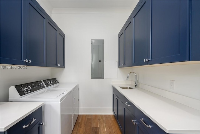 washroom featuring sink, washer and clothes dryer, electric panel, dark hardwood / wood-style floors, and cabinets