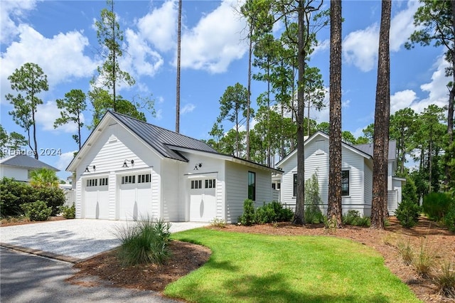 view of front of home featuring a garage and a front lawn