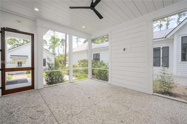 unfurnished sunroom with ceiling fan