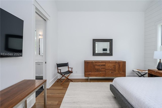 bedroom featuring wood-type flooring and ensuite bathroom