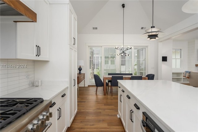 kitchen with white cabinets, tasteful backsplash, pendant lighting, and stainless steel stove