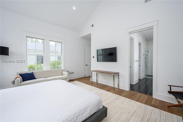 bedroom featuring dark hardwood / wood-style floors and high vaulted ceiling