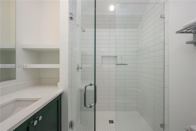 bathroom featuring vanity and a shower with door