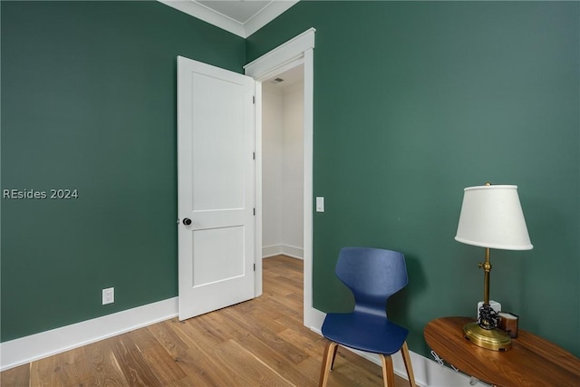 unfurnished room featuring crown molding and light wood-type flooring