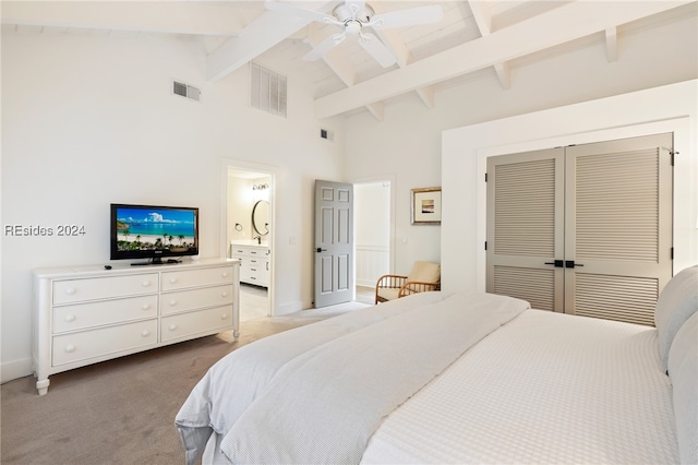 carpeted bedroom with beamed ceiling, high vaulted ceiling, a closet, and ceiling fan