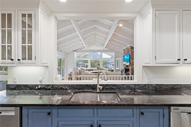 kitchen featuring white cabinets, lofted ceiling with beams, and dishwasher