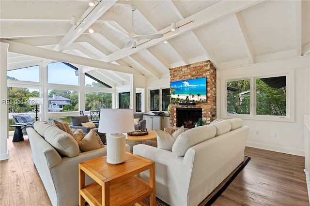 living room featuring hardwood / wood-style flooring, lofted ceiling with beams, a brick fireplace, and wooden ceiling