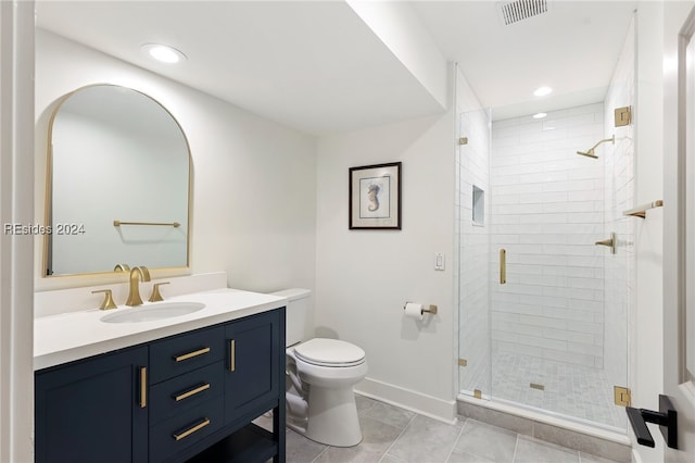 bathroom with vanity, tile patterned flooring, toilet, and walk in shower