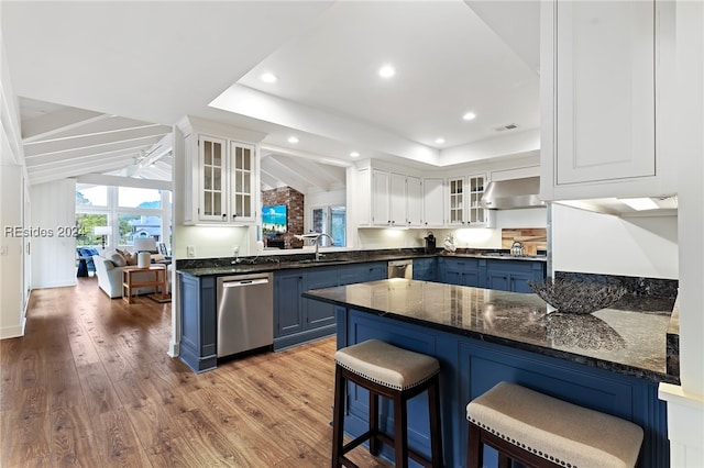 kitchen featuring dishwasher, blue cabinetry, white cabinets, and kitchen peninsula