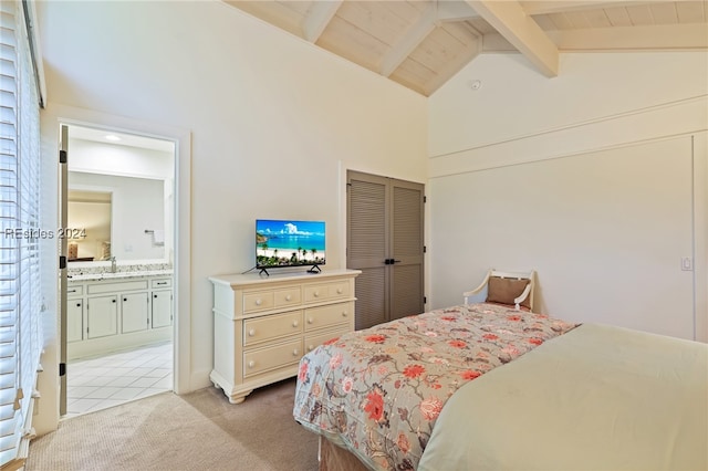 carpeted bedroom with ensuite bathroom, high vaulted ceiling, beamed ceiling, sink, and wood ceiling