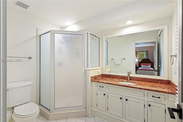 bathroom with vanity, an enclosed shower, tile patterned floors, and toilet