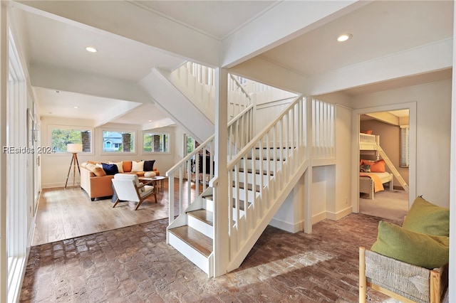 stairway with beamed ceiling