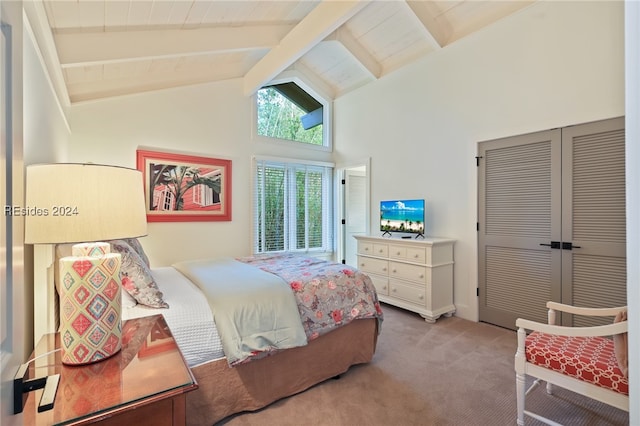 carpeted bedroom with beam ceiling, high vaulted ceiling, and a closet