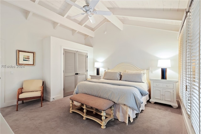 bedroom with ceiling fan, lofted ceiling with beams, a closet, and carpet