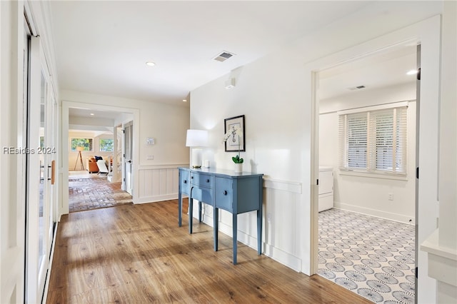 corridor featuring french doors and light hardwood / wood-style flooring