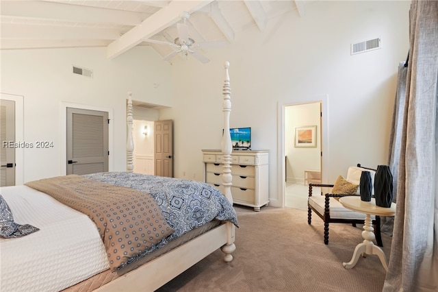 carpeted bedroom with ceiling fan, connected bathroom, beam ceiling, and high vaulted ceiling