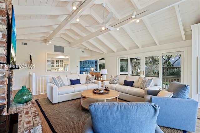 living room featuring hardwood / wood-style floors, track lighting, lofted ceiling with beams, and ceiling fan