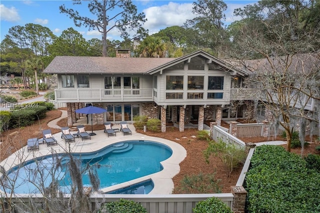 back of house with a patio and a balcony