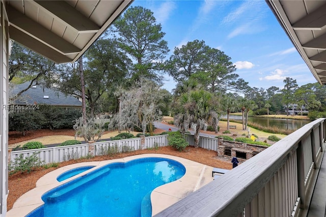 view of pool featuring a water view